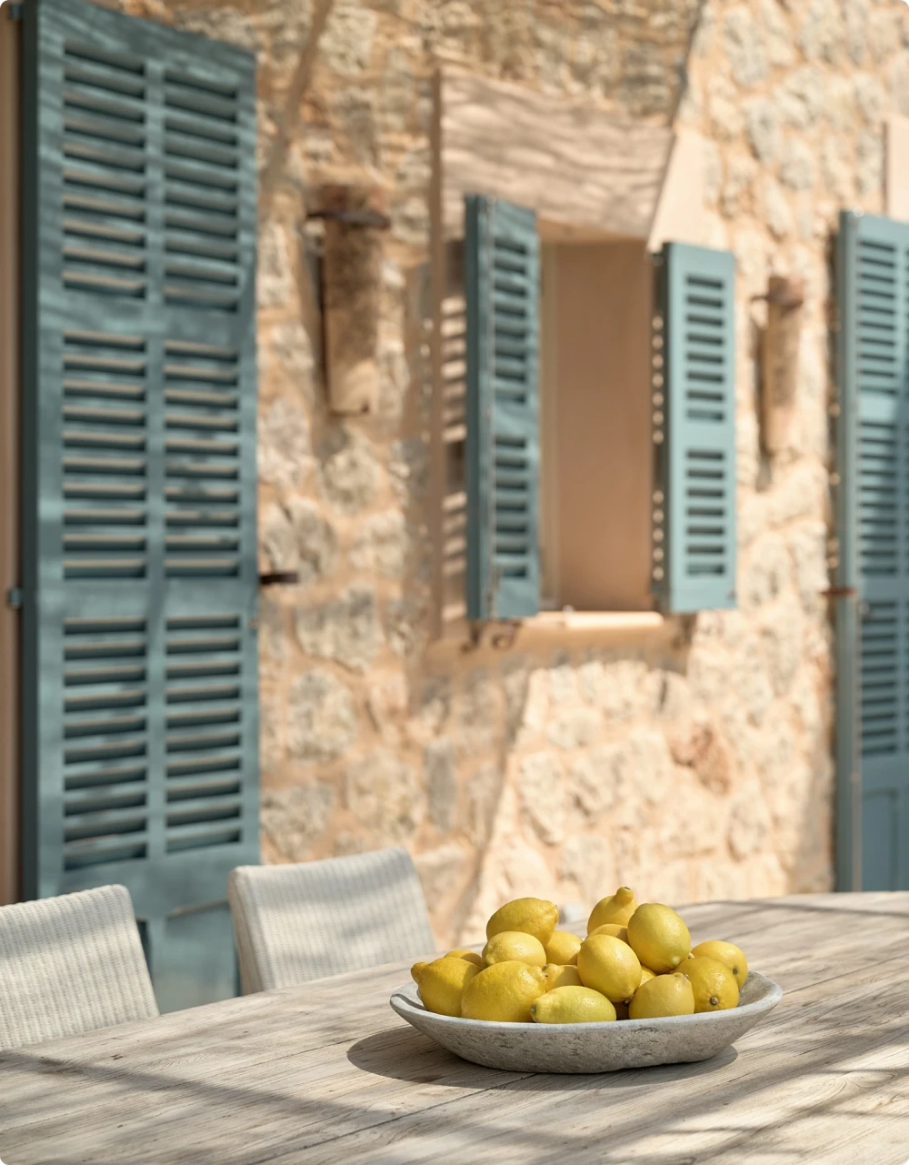 Una mesa al aire libre con un cuenco de limones.